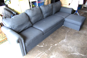 lot 600 image: Modern Modular couch and ottoman with internal storage compartment, completely and easily disassembles in minutes, also includes folding TV tray table