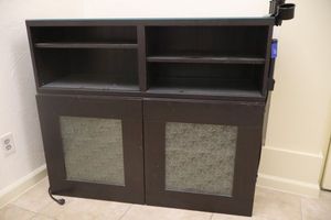 lot 129 image: Entertainment cabinet (has power cord and salon accessory attached