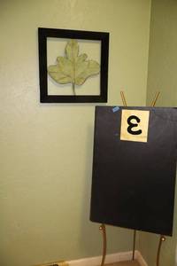 lot 161 image: Metal easel stand and wall art with metal leaf