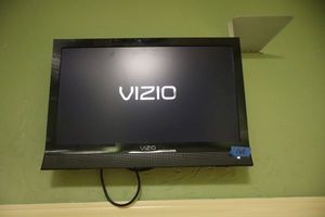lot 165 image: Vizio TV (bring tools to remove). Base piece is included