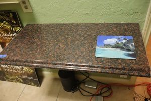 lot 162 image: Stone wall desk with brackets (bring tools to remove)