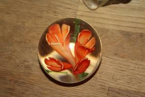 collection of vintage art glass pieces, including a vibrant red glass fish figurine and a spherical floral paperweight and more