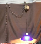 pulley and chain hanging light fixture with a blue shade