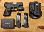 Taurus G2C pistol marked 9mm, with a black textured frame and dark slide. Visible markings include “Taurus,” “Bainbridge, GA,” and “Taurus Armas — Made in Brazil.
