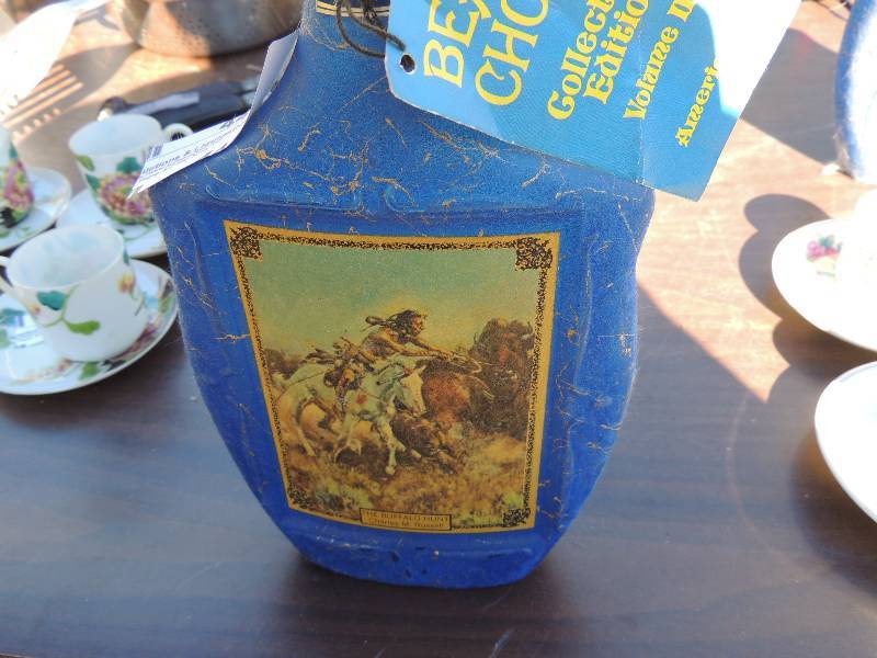 lot 441 image: 2 decanters Beams Choice  - Buffalo herd by C. Russell   and On the trail by F. Remington