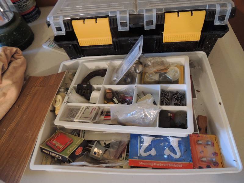 lot 703 image: Black and yellow tool box with sockets, plugs etc., mounting hard wear, corner brads and nails
