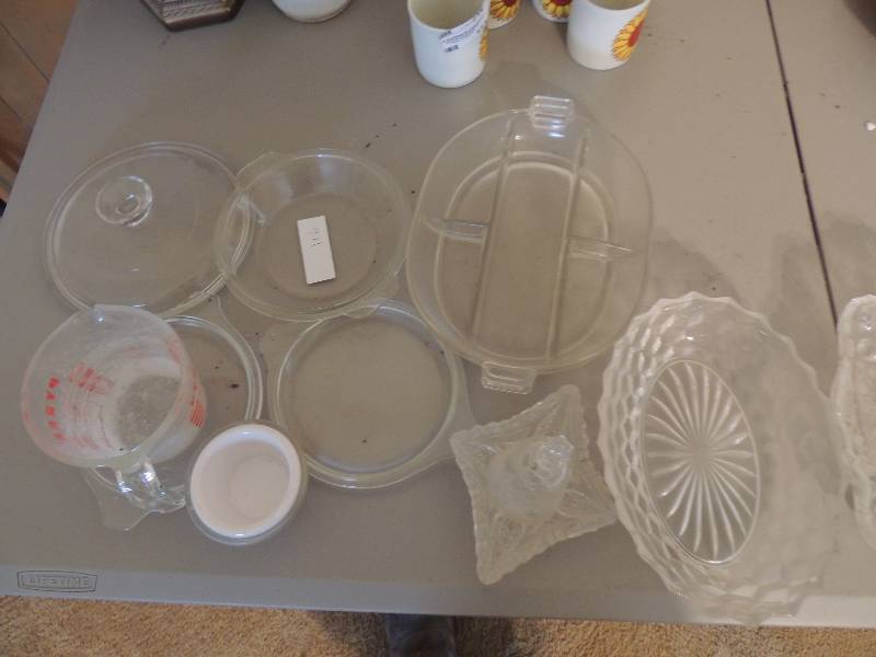 lot 711 image: 5 Corning ware tops 10 Pyrex measuring cups 2 butter server dippers, 3 divided platters and serving bell