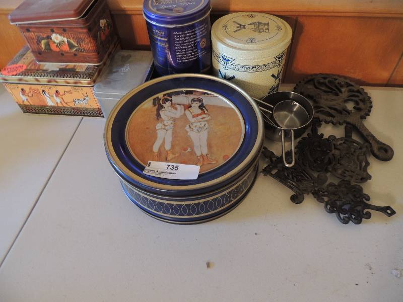 lot 735 image: Metal tins and trivets