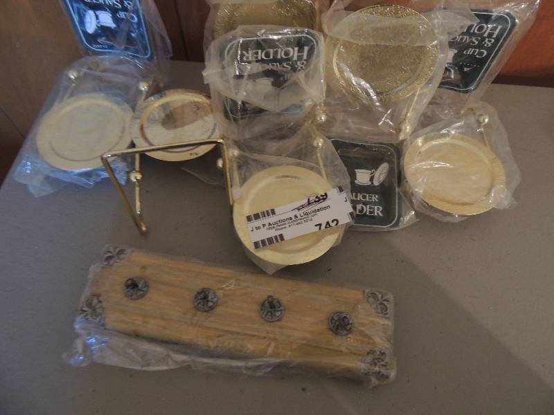 lot 742 image: NEW cup and saucer holders x 6 and set of cow hooks