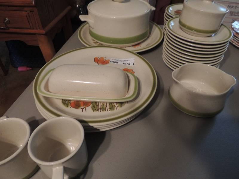 lot 1078 image: Meadowbrook dishware- serving plate, 12 saucers,12 plates, butter dish, crockpot, creamer, 2 cups, 4 dinner plates