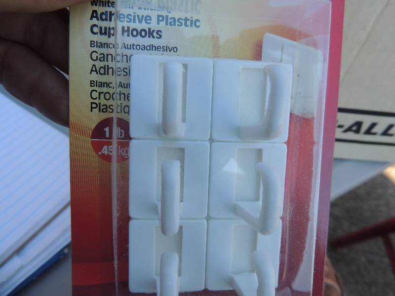 lot 986 image: zip ties, Velcro, molt.. Cans of paint thinner and plastic adhesive hooks