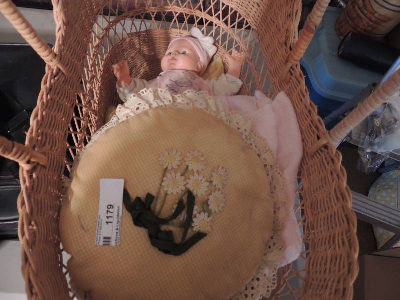 lot 1179 image: Baby doll in a basket