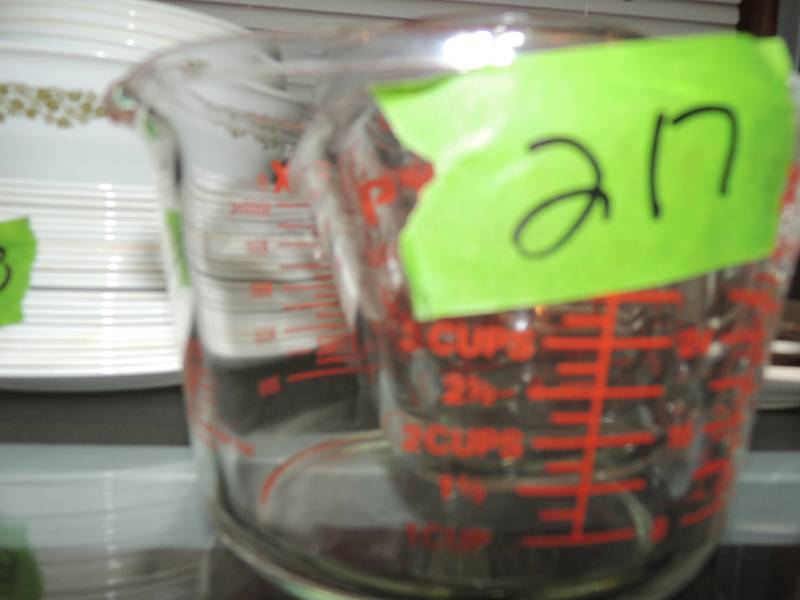 lot 217 image: 5 measuring cups Pyrex,  vinegar bottle