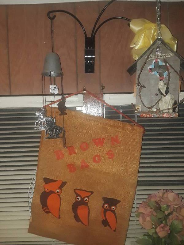 lot 52 image: Horse wind chime and brown bag owls and bird house with hound on porch