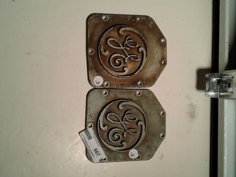 lot 667 image: 2 GE metal stamp plates  and chevy hubcap