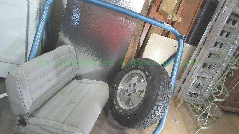 lot 127 image: 1988 Jeep roll bar, rear seat and spare tire