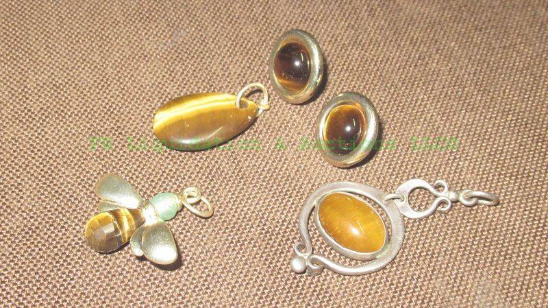 lot 249 image: Tiger eye stone pendants and earrings
