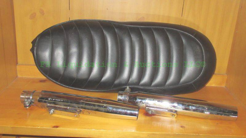 lot 187 image: Triumph motorcycle seat and exhaust mufflers (2)