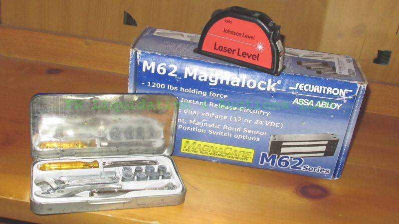lot 198 image: Johnson laser level, Securitron M62 Magnalock, and 16 pc. ratchet tool set