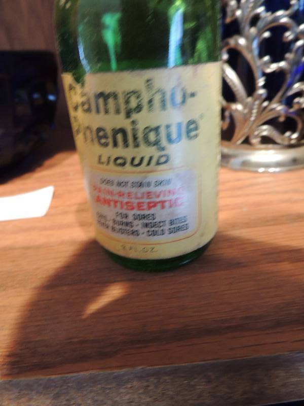 lot 64 image: Mex Vics Vapor rub bottle, blue glass with silver handle, gren glass bottle of used campho phenique