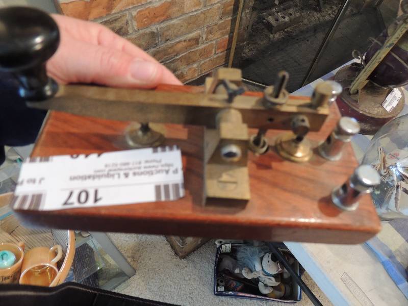 lot 107 image: TELEGRAPH KEY MORSE CODE  - CHINESE MADE  and RAILROAD SPIKE