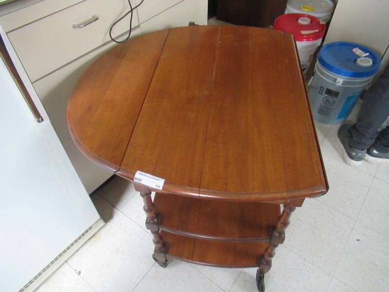lot 59 image: LEWISBURG CHAIR AND FURNITURE CO. COLLAPSIBLE TABLE WITH HANDLE AND CASTORS