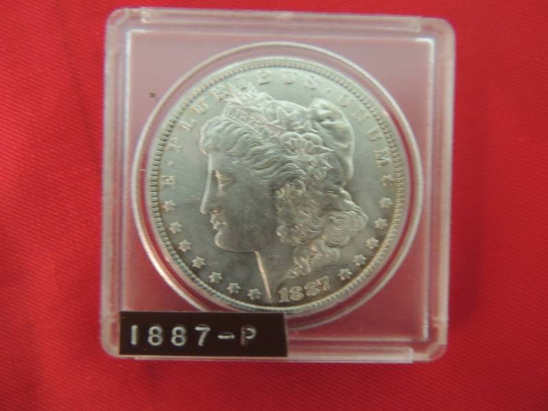 lot 74 image: Morgan Silver Dollar 1887 P in hard case. GREAT luster