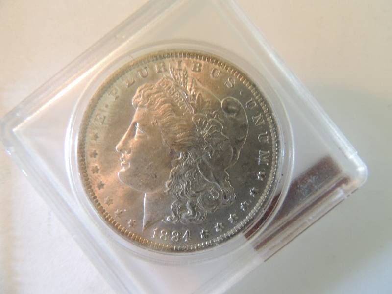 lot 100 image: Morgan Silver Dollar 1884 O  in case. GREAT luster