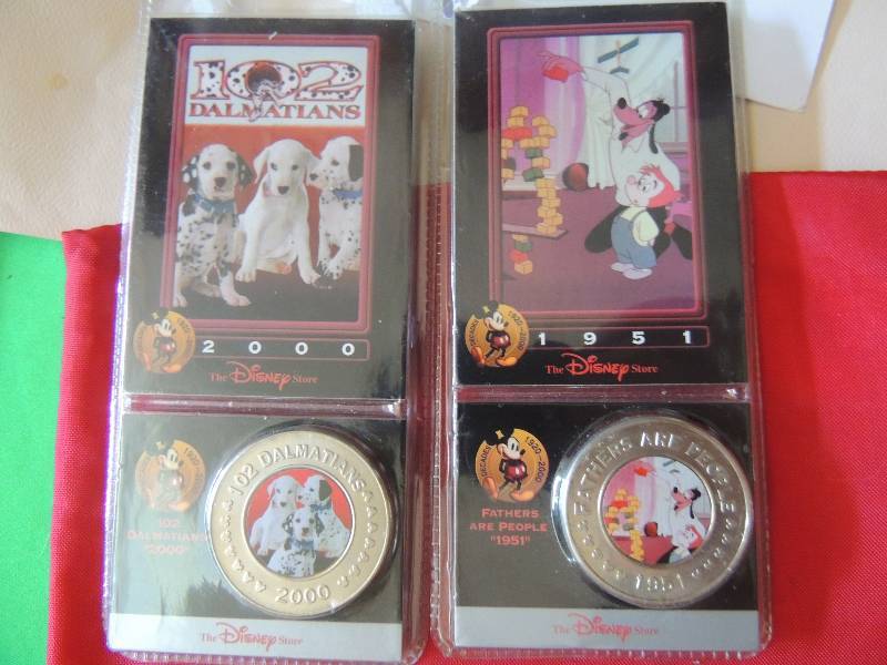 lot 199 image: Disney Decade Coins x 2. Fathers Are People 1951 and 102 Dalmatians 2000