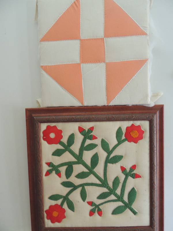 lot 103 image: 2 Quilt blocks. A) Vintage framed  red flower F17x17 b) Newer unframed American Beauty pattern F 13x131