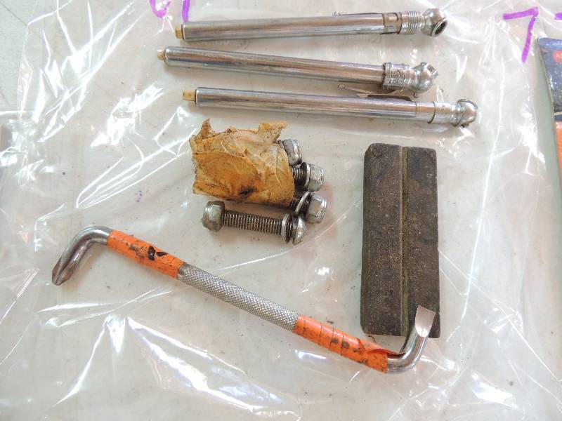 lot 71 image: tire guage x 3, converted screwdriver, and wet stone