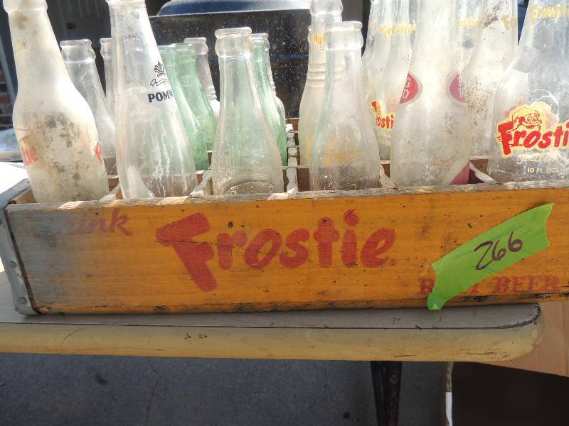 lot 266 image: Frostie Root Beer  Crate contains Frostie, Coke, Big Red and DR. PEPPER bottles (embossed)
