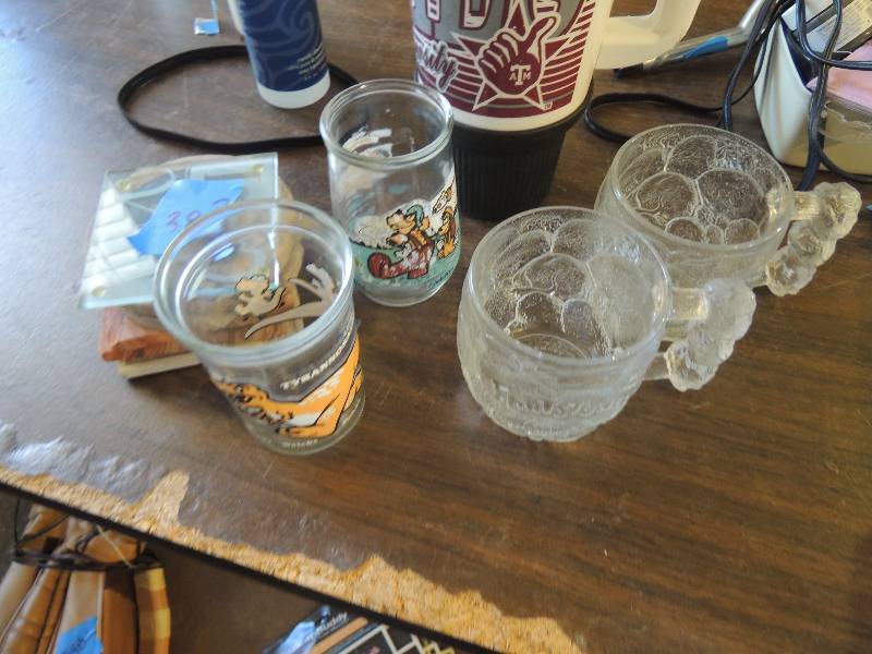 lot 383 image: Lot of kitchen ware- COASTERS, DRDINKING GLASSES, A&M THERMOS, FLINTSTONE CUPS as pictured