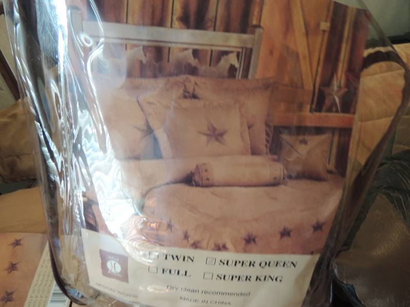 lot 437 image: Super Queen size Texas Bed Set. Includes toss pillows, neck roll, comforter and shams with dust ruffle