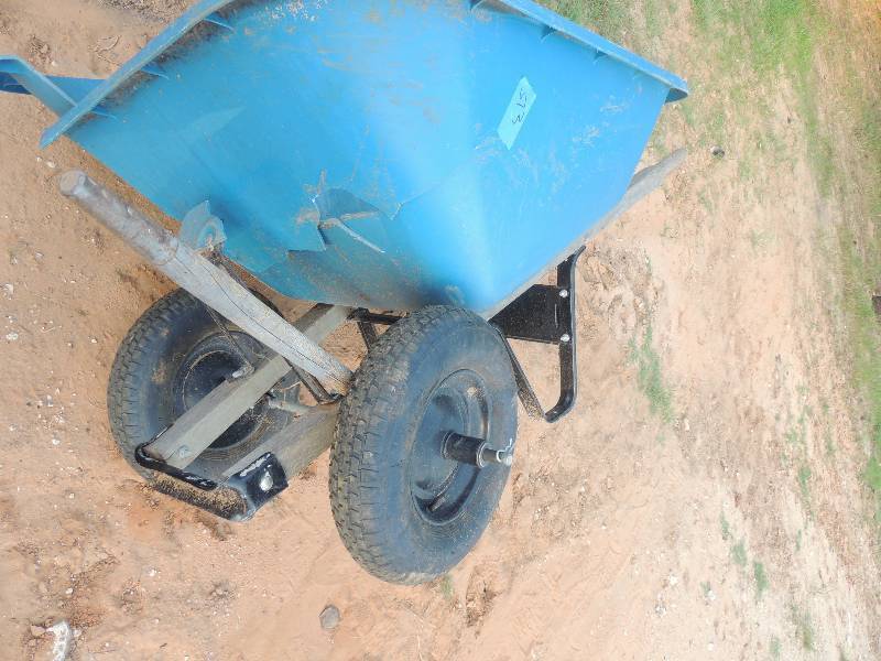 lot 513 image: Blue dual wheel wheelbarrow bucket damaged - see picture