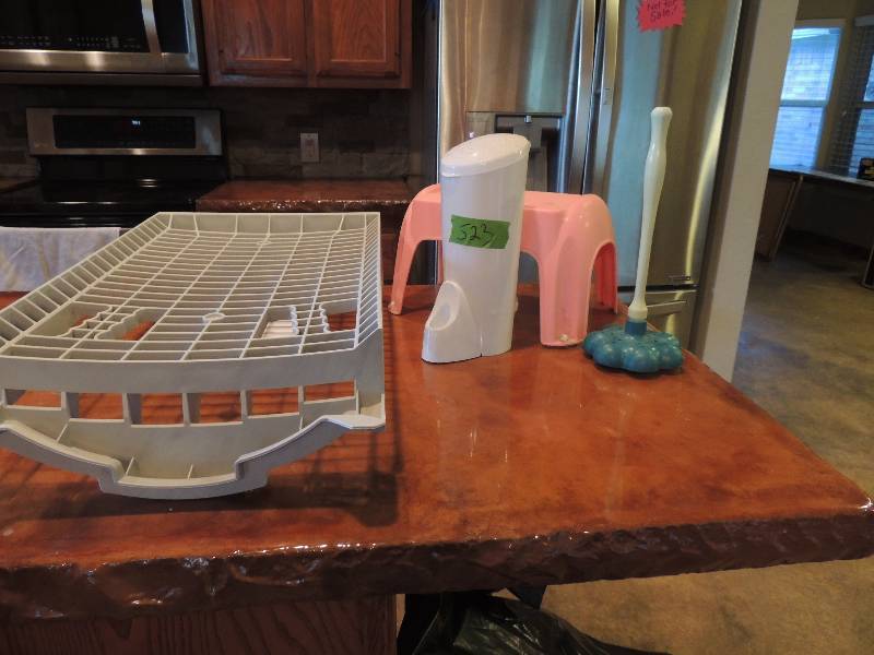 lot 523 image: Pink step stool, dish rack, plunger, and toilet brush holder