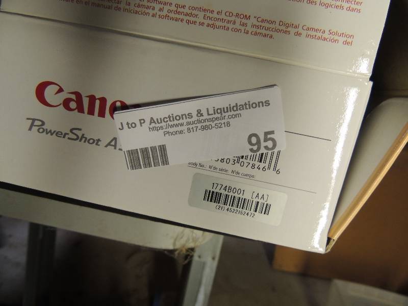 lot 95 image: Cannon camera with case all in box with instruction plus 4 flip phones