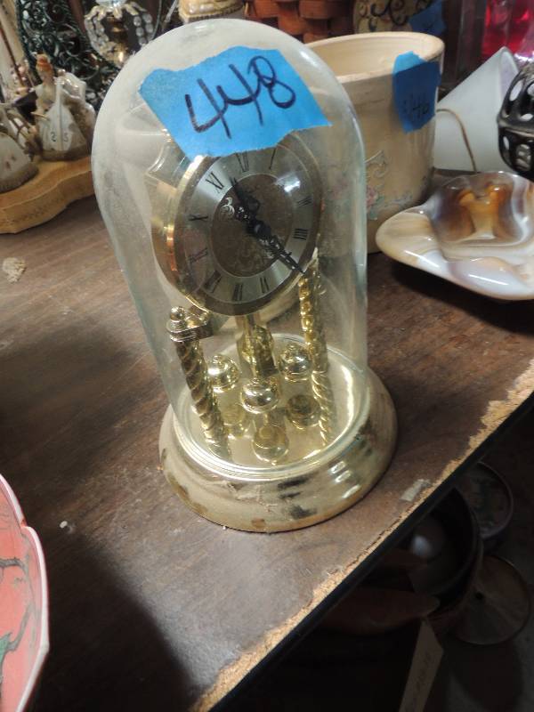 lot 448 image: Gold clock on stand with glass cover  anniversary clock