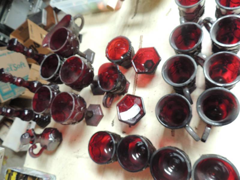 lot 174 image: AVON glass- RUBY RED  3-1876 Cape Cod collection. Candle sticks, creamer, sugar, fruit bowls, coffee mugs, wine glasses