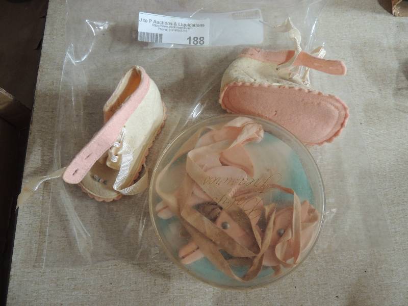 lot 188 image: Blanket fasteners and baby shoes