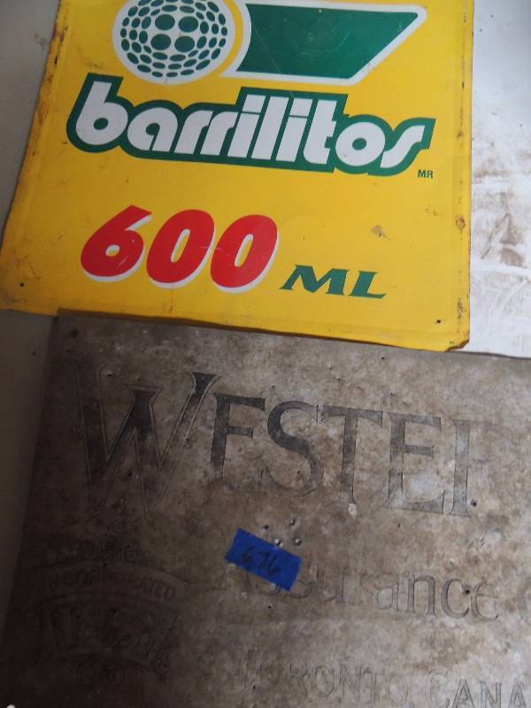 lot 676 image: 2 metal signs- Barrilitos 16x16 600 mls and WESTERN CANADA