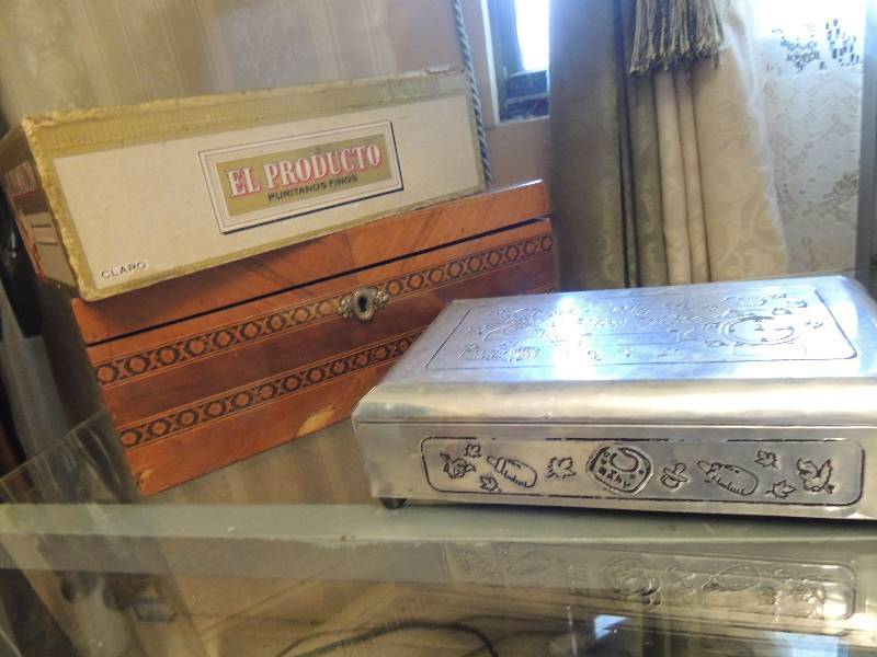 lot 17 image: My first video silver cigarette box brown cigar box El Producto cigar box