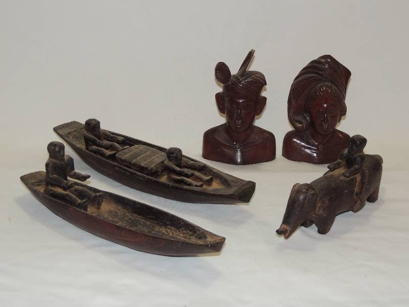 lot 185 image: 2 Mayan carved boats with occupants 15 long and Man riding an animal and carved Rosewood bust of an Amazon couple