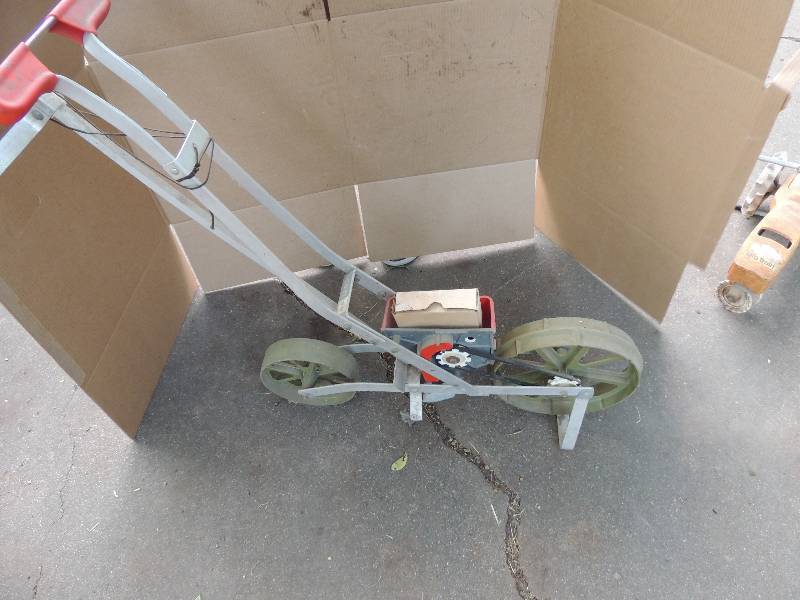 lot 571 image: Vintage solid metal water sprinkler (tracker), Vintage seed spreader with  SEED DISCS
