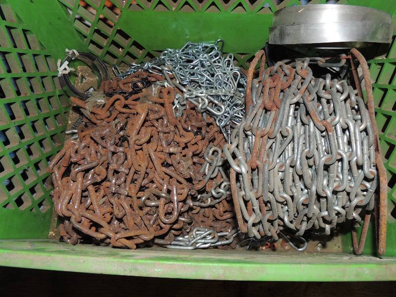 lot 603 image: Green basket full of various Chains different sizes