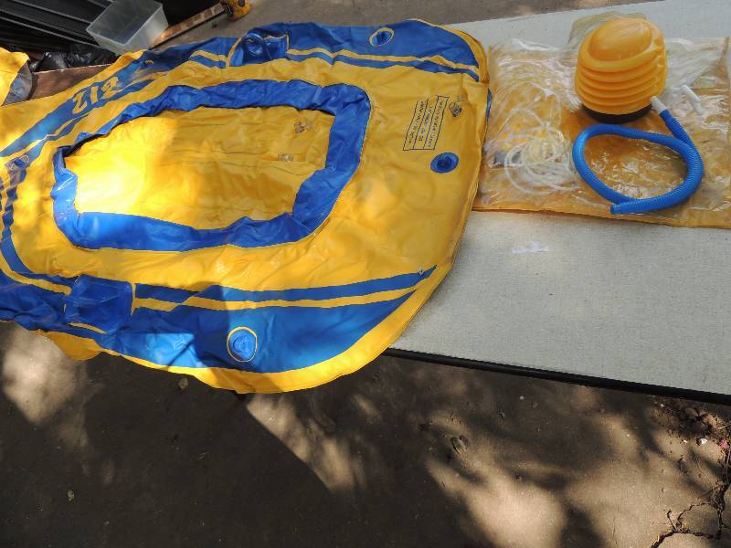 lot 614 image: 2- two passenger boat floats blueyellow 1 is in need of repair for small hole. Both come with paddles and pump