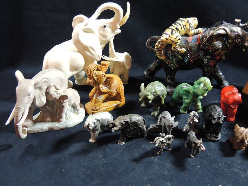 lot 218 image: Elephants- large quantity- consists of ceramic, white with gold, bejeweled, Kenya collection glass, onyx and coal.
