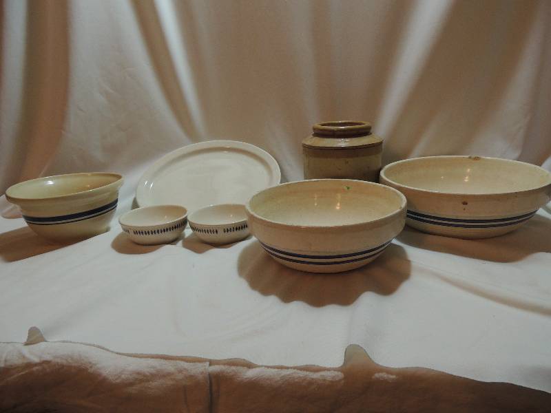 lot 151 image: Crock bowl-  3 bowls which one is Roseville Ohio, 1 Utensil crock, 2 blue band mixing bowls with crazing and cracks ( see pics) and 2 Homer Laughlin bowls and 1 serving plate.