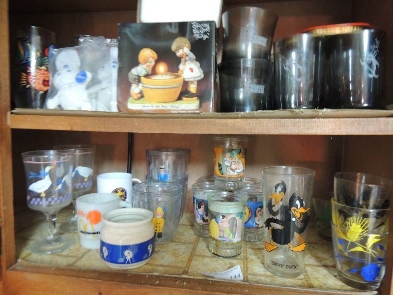 lot 144 image: Corporate Branding items-Pillsbury doughboy plush, Hershey candle, Sorry Charlie (Chicken of the Sea) glass set, various Disney glasses.