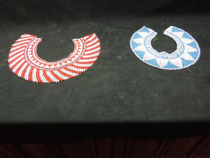 lot 239 image: South American Tribal Beaded collarsQTY 2 - blue and white sun burst and red and white  swirl